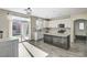 Well-lit kitchen featuring white cabinets, stainless appliances, and a central island with a wooden base at 9021 Rendon St, Las Vegas, NV 89143