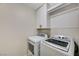 Laundry room with a full size washer and dryer, storage, and room for folding at 9021 Rendon St, Las Vegas, NV 89143