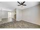 Spacious living area with stylish flooring, a contemporary light fixture, and an open layout to other living spaces at 9021 Rendon St, Las Vegas, NV 89143
