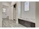 Cozy mud room boasts a built-in bench with storage and a convenient closet, flowing into a nearby bathroom at 9021 Rendon St, Las Vegas, NV 89143
