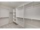 Spacious walk-in closet with lots of storage shelves and hanging rods at 9021 Rendon St, Las Vegas, NV 89143