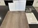 Close-up of kitchen selection showcasing cabinet, counter, and vinyl flooring samples at 9534 Marsh Aster St, Las Vegas, NV 89139