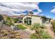 Stunning backyard showcasing a mix of desert landscaping, artificial turf, and breathtaking mountain views for serene living at 10271 Meridian Hill Ave, Las Vegas, NV 89135