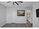 Spacious bedroom with stylish wood-look floors, a ceiling fan, and two doorways at 10271 Meridian Hill Ave, Las Vegas, NV 89135