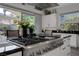 Kitchen features stainless steel stove, white cabinets, granite counters, and sliding glass doors to backyard at 10271 Meridian Hill Ave, Las Vegas, NV 89135
