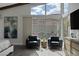 Bright view of the seating area of a main bedroom featuring mountain views and modern decor at 10271 Meridian Hill Ave, Las Vegas, NV 89135