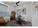 Bright home office with modern desk, two chairs, large window, and art at 10271 Meridian Hill Ave, Las Vegas, NV 89135