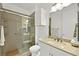 Modern bathroom featuring a glass-enclosed shower, white vanity, and contemporary fixtures at 10920 Grand Haven Ave, Las Vegas, NV 89134