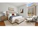 Comfortable bedroom with a large window, neutral tones, and stylish furnishings for a relaxing retreat at 10920 Grand Haven Ave, Las Vegas, NV 89134