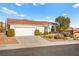 Charming single-story home with a red tile roof, desert landscaping, and a two-car garage at 10920 Grand Haven Ave, Las Vegas, NV 89134