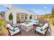 This backyard patio features a stone fire pit, comfortable seating, and a covered outdoor dining area at 10920 Grand Haven Ave, Las Vegas, NV 89134