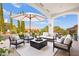 Stylish covered patio with ample seating, ideal for entertaining and enjoying scenic views of the meticulously landscaped surroundings at 10920 Grand Haven Ave, Las Vegas, NV 89134