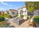 Charming patio features a modern fire pit, comfortable seating, and lush landscaping, perfect for relaxation and social gatherings at 10920 Grand Haven Ave, Las Vegas, NV 89134