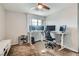 This bedroom features a ceiling fan and a modern desk setup with multiple monitors at 113 Manzanita Falls Ave, North Las Vegas, NV 89031