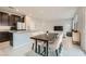 Open-concept kitchen and dining area with stainless steel appliances and a view to the living room at 113 Manzanita Falls Ave, North Las Vegas, NV 89031