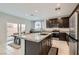 Modern kitchen with stainless appliances, granite countertops, and an island, perfect for cooking and entertaining at 113 Manzanita Falls Ave, North Las Vegas, NV 89031