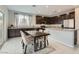 Well-equipped kitchen with stainless steel appliances, granite countertops, and a dining area at 113 Manzanita Falls Ave, North Las Vegas, NV 89031
