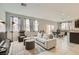 Bright and airy living room with neutral tones, plush seating, and abundant natural light at 113 Manzanita Falls Ave, North Las Vegas, NV 89031