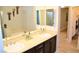Bathroom with dual sinks, a vanity, a large mirror, and a separate tub and shower at 11830 Portina Dr # 2030, Las Vegas, NV 89138