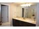 Bathroom featuring dual sinks, granite countertops, a large mirror, and a separate tub and shower at 11830 Portina Dr # 2030, Las Vegas, NV 89138