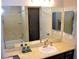 Bathroom featuring a large mirror, a vanity with sink, and a tub with shower at 11830 Portina Dr # 2030, Las Vegas, NV 89138