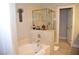 Bathroom featuring a bathtub, glass enclosed shower, and access to additional rooms at 11830 Portina Dr # 2030, Las Vegas, NV 89138