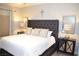Comfortable bedroom featuring a padded headboard, side tables, and natural light at 11830 Portina Dr # 2030, Las Vegas, NV 89138