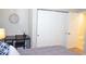 Bedroom with desk, closet, and door to hallway, decorated with modern wall art at 11830 Portina Dr # 2030, Las Vegas, NV 89138