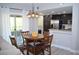 Cozy dining area with a dark kitchen, slider to patio, and modern pendant lighting at 11830 Portina Dr # 2030, Las Vegas, NV 89138