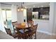 Open concept dining area with a dark kitchen and patio access at 11830 Portina Dr # 2030, Las Vegas, NV 89138