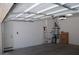 Spacious garage interior with door, ladder, water heater, and ample room for parking and storage at 11830 Portina Dr # 2030, Las Vegas, NV 89138