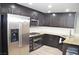 Modern kitchen with stainless steel appliances, granite countertops, and dark cabinetry at 11830 Portina Dr # 2030, Las Vegas, NV 89138
