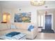 Stylish living room blending seamlessly with the entryway, featuring a sectional sofa and artwork at 11830 Portina Dr # 2030, Las Vegas, NV 89138