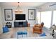 Bright living room with a cozy seating area, modern lighting, and decorative wall art at 11830 Portina Dr # 2030, Las Vegas, NV 89138