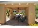 Outdoor kitchen in covered pavilion, complete with grill, ceiling fan, patio table, and low maintenance landscaping at 11830 Portina Dr # 2030, Las Vegas, NV 89138