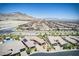 Elevated view showing a neighborhood with well-maintained homes, pools, landscaping, and scenic mountain backdrop at 12168 Dorada Coast Ave, Las Vegas, NV 89138