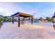 Beautiful backyard design with an outdoor kitchen area, covered patio, sparkling pool, and lovely landscaping at 12168 Dorada Coast Ave, Las Vegas, NV 89138