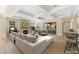Staged living room showcasing an open layout, fireplace, and access to outdoor patio at 12168 Dorada Coast Ave, Las Vegas, NV 89138