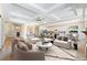 Staged living room showcasing the fireplace and is open to kitchen and dining area at 12168 Dorada Coast Ave, Las Vegas, NV 89138