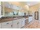 Bright primary bathroom with double sinks, ceramic floors and a walk-in shower at 12168 Dorada Coast Ave, Las Vegas, NV 89138