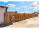 Fenced backyard with a wooden privacy fence and signage indicating the presence of a dog at 1328 Balzar Ave, Las Vegas, NV 89106