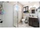 Cozy bathroom with a shower, dark vanity, and tiled floors at 1328 Balzar Ave, Las Vegas, NV 89106