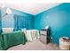 Bedroom with blue walls, two covered tables and a mini-fridge at 1328 Balzar Ave, Las Vegas, NV 89106