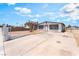 Single-story home with long driveway and secure white fence, minimal landscaping at 1328 Balzar Ave, Las Vegas, NV 89106