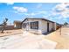 Single-story home with white walls and a long driveway next to a dead tree at 1328 Balzar Ave, Las Vegas, NV 89106