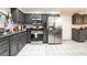 Functional kitchen with stainless steel appliances and grey cabinetry with tile floors throughout at 1328 Balzar Ave, Las Vegas, NV 89106
