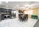 Well-lit kitchen with stainless steel appliances, dining area, tile floors, grey cabinets and rear door access at 1328 Balzar Ave, Las Vegas, NV 89106