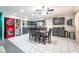 Bright and airy kitchen featuring stainless steel appliances, tile floors, grey cabinetry, and direct dining room access at 1328 Balzar Ave, Las Vegas, NV 89106