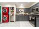 Close-up of convenient laundry area with stacked washer/dryer adjacent to the kitchen with painted grey cabinets at 1328 Balzar Ave, Las Vegas, NV 89106