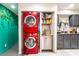 Convenient laundry area with stacked washer/dryer adjacent to the kitchen with painted grey cabinets at 1328 Balzar Ave, Las Vegas, NV 89106